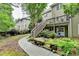 Image of a backyard with a landscaped rock garden, wooden deck, stairway, and lush green vegetation at 1640 Mount Mckinley Dr, Grayson, GA 30017