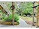 Serene backyard with lush greenery, a charming seating area, and stone walkway at 1640 Mount Mckinley Dr, Grayson, GA 30017