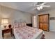 Comfortable bedroom featuring a ceiling fan and a view into the en-suite bathroom at 1640 Mount Mckinley Dr, Grayson, GA 30017