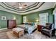 Bright bedroom with a tray ceiling, ceiling fan and hardwood floors at 1640 Mount Mckinley Dr, Grayson, GA 30017
