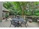 Relaxing outdoor deck features table with four chairs and wooded scenery at 1640 Mount Mckinley Dr, Grayson, GA 30017