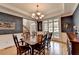 Elegant dining room with hardwood floors, chandelier, and wainscoting at 1640 Mount Mckinley Dr, Grayson, GA 30017