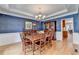 Elegant dining room with hardwood floors, chandelier, and wainscoting at 1640 Mount Mckinley Dr, Grayson, GA 30017