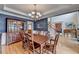 Elegant dining room with hardwood floors, chandelier, and wainscoting at 1640 Mount Mckinley Dr, Grayson, GA 30017