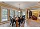Sunlit dining room featuring tile floors, a view of the deck, and easy access to living area at 1640 Mount Mckinley Dr, Grayson, GA 30017