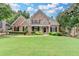 Charming brick home with manicured lawn, lush landscaping and inviting front porch at 1640 Mount Mckinley Dr, Grayson, GA 30017