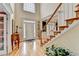Spacious foyer featuring hardwood floors, staircase, and natural light at 1640 Mount Mckinley Dr, Grayson, GA 30017