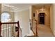 Hallway with carpet and natural light featuring a chandelier at the stairwell at 1640 Mount Mckinley Dr, Grayson, GA 30017