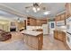 Open kitchen featuring wood cabinets, island, and adjacent living room, creating a spacious and inviting area at 1640 Mount Mckinley Dr, Grayson, GA 30017