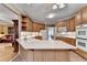 Bright kitchen with wooden cabinets, light countertops, tile flooring, and stainless steel appliances at 1640 Mount Mckinley Dr, Grayson, GA 30017