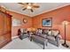 Inviting living room featuring a ceiling fan, leather furniture, and classic design at 1640 Mount Mckinley Dr, Grayson, GA 30017