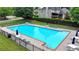 Sparkling community pool with ample lounge seating and shaded tables at 1640 Mount Mckinley Dr, Grayson, GA 30017