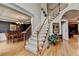 Elegant staircase with hardwood floors, carpeted steps, and adjacent dining room at 1640 Mount Mckinley Dr, Grayson, GA 30017