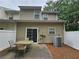 Back patio with a table and chairs, surrounded by a privacy fence and pine straw at 2131 Meadow Peak Rd, Duluth, GA 30097