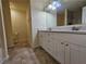 Bathroom featuring a double sink vanity, tile floors, and a shower at 2131 Meadow Peak Rd, Duluth, GA 30097