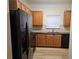 Modern kitchen with black appliances, wood cabinets, and ample counter space at 2131 Meadow Peak Rd, Duluth, GA 30097