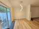Sunlit living room featuring a glass sliding door to a patio, crown molding, and wood floors at 2131 Meadow Peak Rd, Duluth, GA 30097