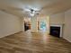 Spacious living room featuring wood floors, a fireplace, and an open floor plan to the kitchen at 2131 Meadow Peak Rd, Duluth, GA 30097