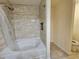 Modern bathtub and shower with tiled surround and a built-in niche at 2131 Meadow Peak Rd, Duluth, GA 30097