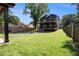 Large backyard with fire pit and a home featuring a multiple decks and a well-manicured lawn at 2608 Argo Drive Southeast Se Dr, Smyrna, GA 30080