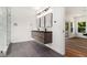 Modern bathroom featuring a floating double vanity, sleek mirrors, and a glass-enclosed shower at 2608 Argo Drive Southeast Se Dr, Smyrna, GA 30080
