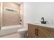 Cozy bathroom with stylish vanity, tile accents, and a shower-tub combination at 2608 Argo Drive Southeast Se Dr, Smyrna, GA 30080