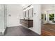 Modern bathroom with floating double vanity, sleek mirrors, and a glass-enclosed shower at 2608 Argo Drive Southeast Se Dr, Smyrna, GA 30080