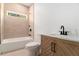 Clean bathroom featuring bathtub-shower combo, toilet, and sink with wood finish cabinet at 2608 Argo Drive Southeast Se Dr, Smyrna, GA 30080