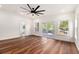 Bright, open bedroom with hardwood floors, large windows, a ceiling fan, and an ensuite bathroom at 2608 Argo Drive Southeast Se Dr, Smyrna, GA 30080