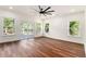 Spacious bedroom with hardwood floors, large windows providing natural light, and a modern ceiling fan at 2608 Argo Drive Southeast Se Dr, Smyrna, GA 30080