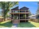 Two-story home with a modern exterior featuring multiple decks and verdant lawn at 2608 Argo Drive Southeast Se Dr, Smyrna, GA 30080