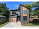 Charming home with modern architecture, a wooden garage door and sleek gray siding at 2608 Argo Drive Southeast Se Dr, Smyrna, GA 30080