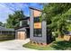 Modern two-story home featuring a gray facade, natural wood accents, and a stylish garage door at 2608 Argo Drive Southeast Se Dr, Smyrna, GA 30080