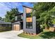 Contemporary home featuring a unique wood and gray facade, modern garage door, and manicured lawn at 2608 Argo Drive Southeast Se Dr, Smyrna, GA 30080