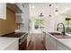 Modern kitchen features stainless steel appliances, white countertops, stylish backsplash, and open layout to dining area at 2608 Argo Drive Southeast Se Dr, Smyrna, GA 30080