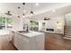 Modern kitchen island, featuring quartz countertops, a sleek faucet, and views of the living room and deck at 2608 Argo Drive Southeast Se Dr, Smyrna, GA 30080