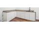 Stylish kitchenette featuring white cabinets, dark hardwood floors and a granite countertop at 2608 Argo Drive Southeast Se Dr, Smyrna, GA 30080