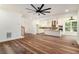 Open-concept living room and kitchen with hardwood floors and modern lighting fixtures at 2608 Argo Drive Southeast Se Dr, Smyrna, GA 30080