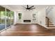 Open living room with hardwood floors, a modern fireplace, and sliding doors leading to an outdoor deck at 2608 Argo Drive Southeast Se Dr, Smyrna, GA 30080