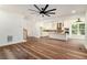 Spacious living room with hardwood floors and modern ceiling fan opens up to kitchen with island at 2608 Argo Drive Southeast Se Dr, Smyrna, GA 30080