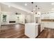 Open-concept living space with fireplace, wood floors and a view of the kitchen island at 2608 Argo Drive Southeast Se Dr, Smyrna, GA 30080