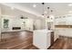 Open-concept living area featuring a fireplace and a modern kitchen island with pendant lighting at 2608 Argo Drive Southeast Se Dr, Smyrna, GA 30080