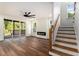 Bright living room with hardwood floors, a fireplace, stairs, and sliding doors to a deck at 2608 Argo Drive Southeast Se Dr, Smyrna, GA 30080