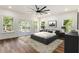 Spacious primary bedroom with large windows, hardwood floors, and a stylish platform bed at 2608 Argo Drive Southeast Se Dr, Smyrna, GA 30080