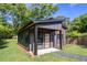 Modern outbuilding with gray siding, natural wood accents, and lush green lawn at 2608 Argo Drive Southeast Se Dr, Smyrna, GA 30080