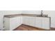Wet bar with white cabinets, granite countertops, and wood flooring at 2608 Argo Drive Southeast Se Dr, Smyrna, GA 30080