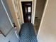 Hallway featuring a blue rug and doorway leading to other rooms at 3415 Spring Valley Blvd, Atlanta, GA 30349