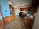 Kitchen featuring wood cabinets, linoleum flooring and granite countertops at 3415 Spring Valley Blvd, Atlanta, GA 30349