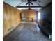Living room featuring wood paneling, a fireplace, and beamed ceilings at 3415 Spring Valley Blvd, Atlanta, GA 30349