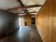 Spacious living room featuring wood paneling, a fireplace, and beamed ceilings at 3415 Spring Valley Blvd, Atlanta, GA 30349